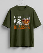 Xenovaurban oversized T-shirt featuring At My Age I Need Glasses quote and illustrated whiskey glass