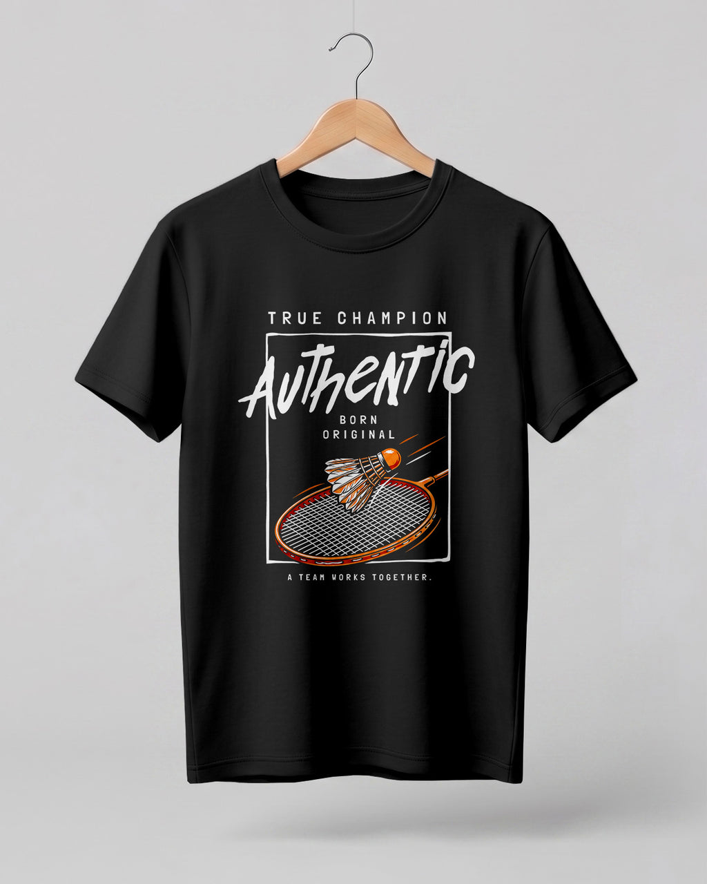 Motivational sports graphic half sleeve t-shirt featuring badminton racket and shuttlecock with “True Champion Authentic Born Original A Team Works Together” typography design on premium cotton fabric.