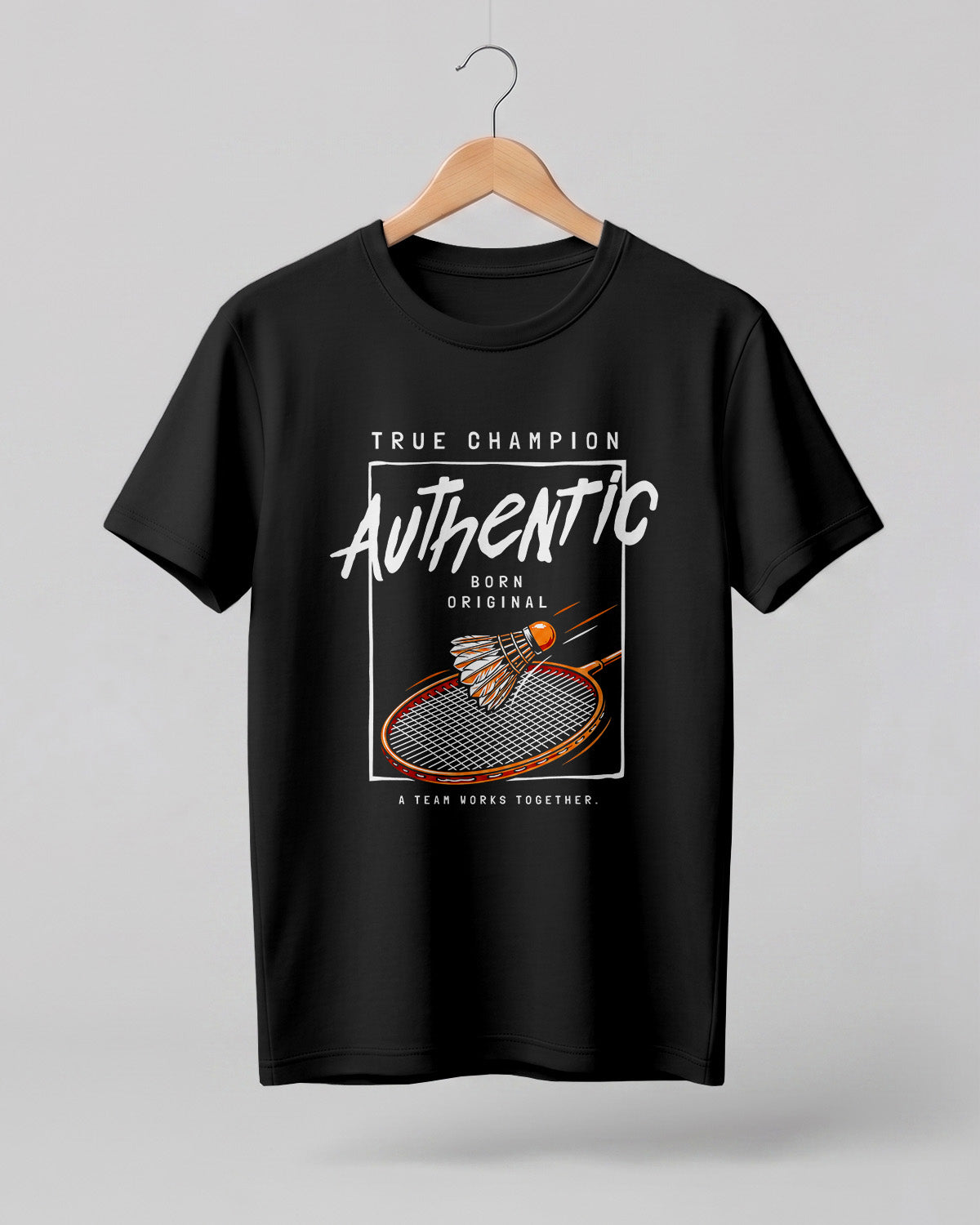 Motivational sports graphic half sleeve t-shirt featuring badminton racket and shuttlecock with “True Champion Authentic Born Original A Team Works Together” typography design on premium cotton fabric.