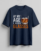 Xenovaurban oversized T-shirt featuring At My Age I Need Glasses quote and illustrated whiskey glass