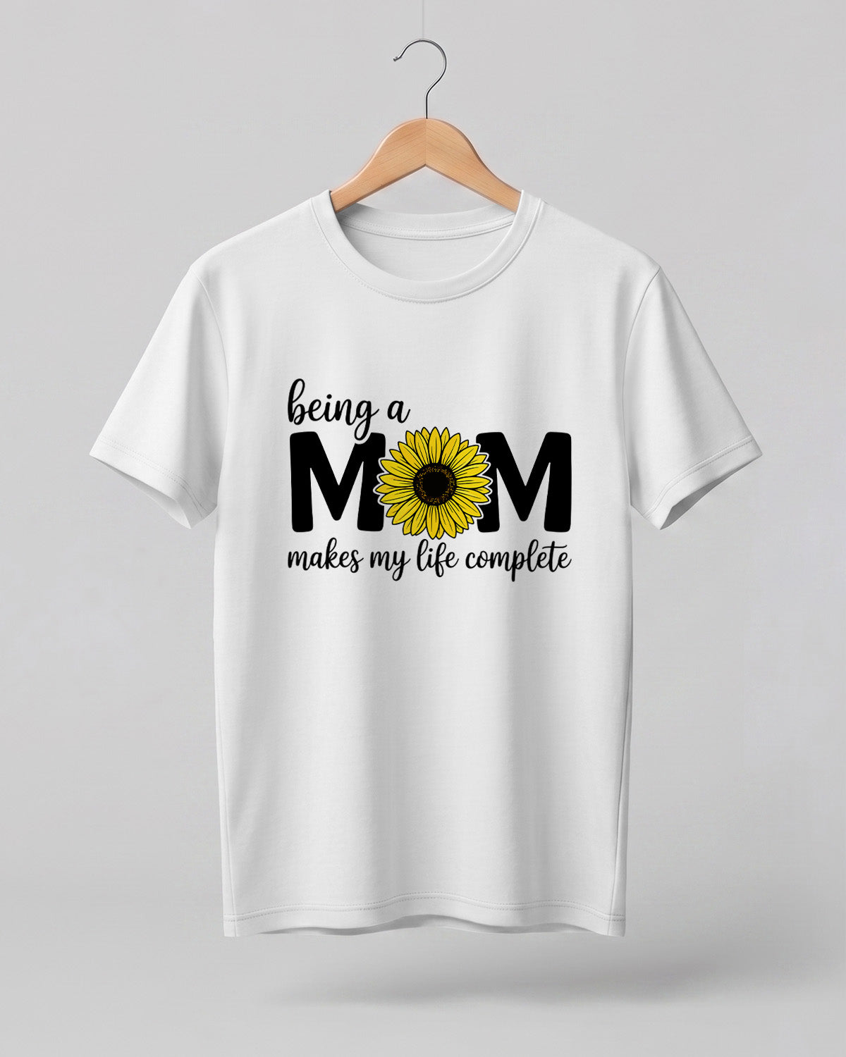Mom quote graphic half sleeve t-shirt featuring “Being a MOM makes my life complete” with sunflower design