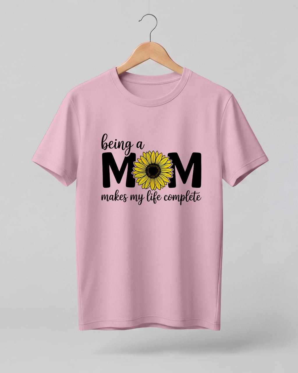 Mom quote graphic half sleeve t-shirt featuring “Being a MOM makes my life complete” with sunflower design