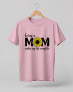 Mom quote graphic half sleeve t-shirt featuring “Being a MOM makes my life complete” with sunflower design