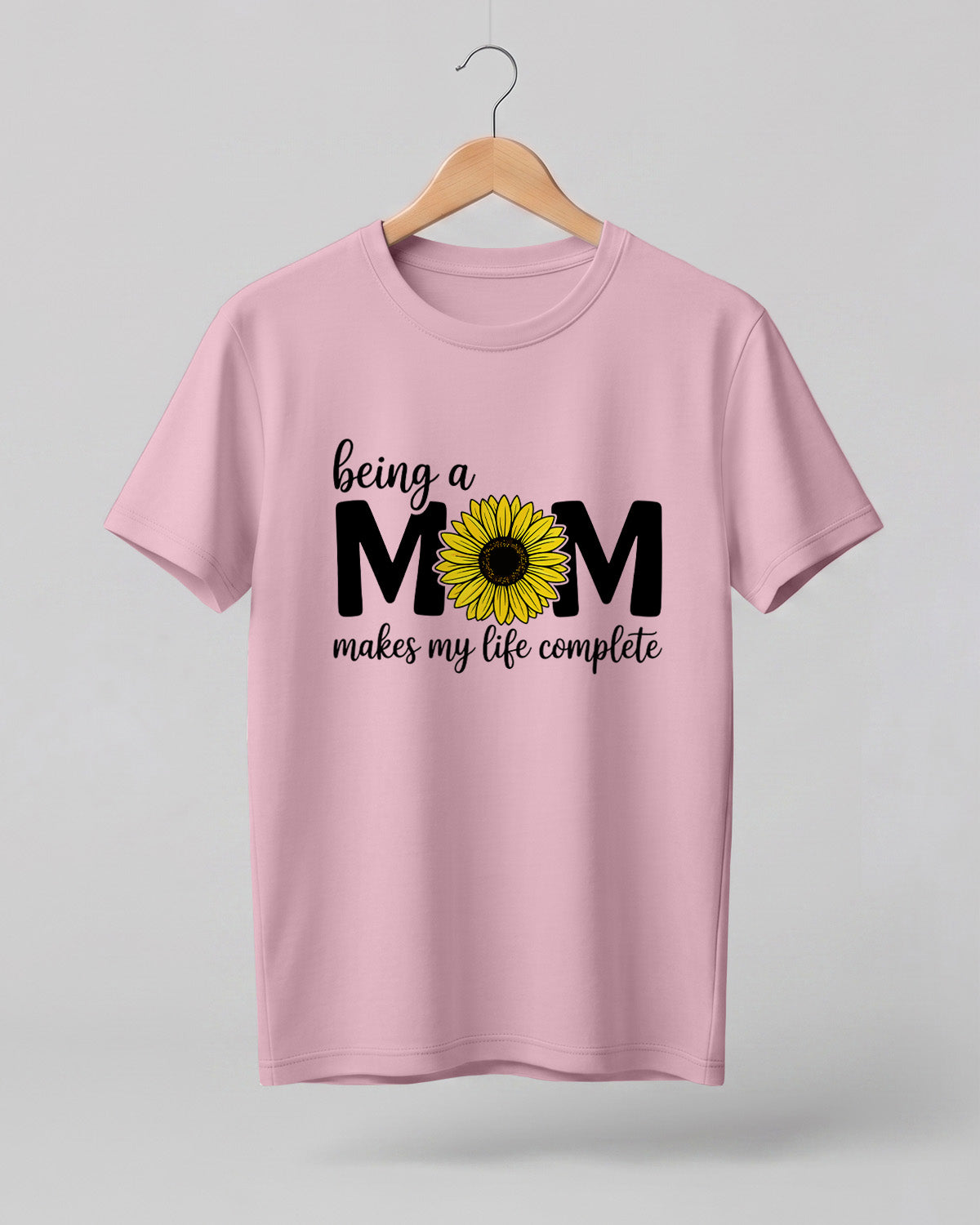 Mom quote graphic half sleeve t-shirt featuring “Being a MOM makes my life complete” with sunflower design