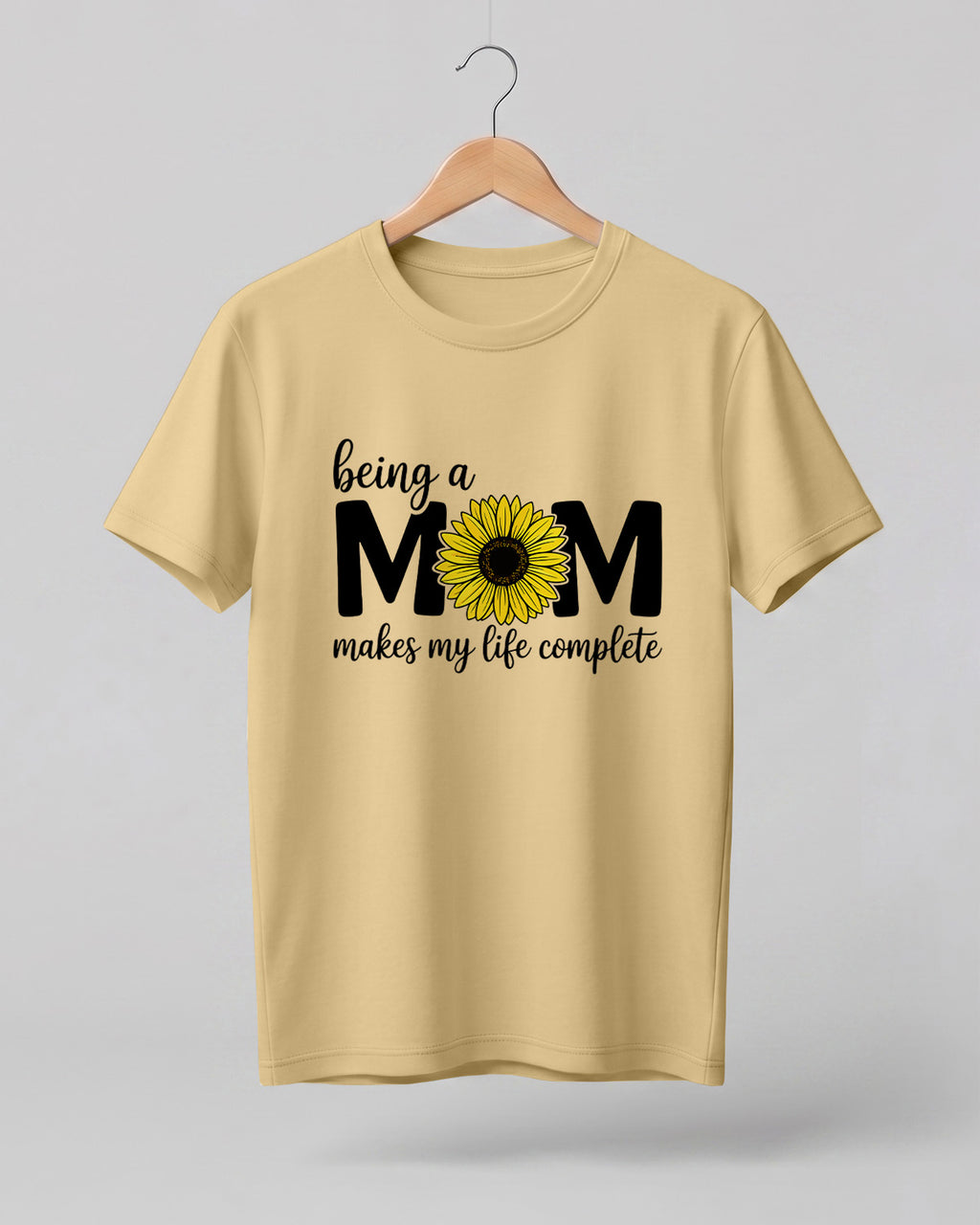 Mom quote graphic half sleeve t-shirt featuring “Being a MOM makes my life complete” with sunflower design