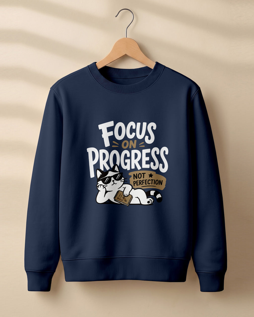 Motivational graphic sweatshirt featuring relaxed cat wearing sunglasses artwork with Focus on Progress, Not Perfection quote printed on cotton fabric