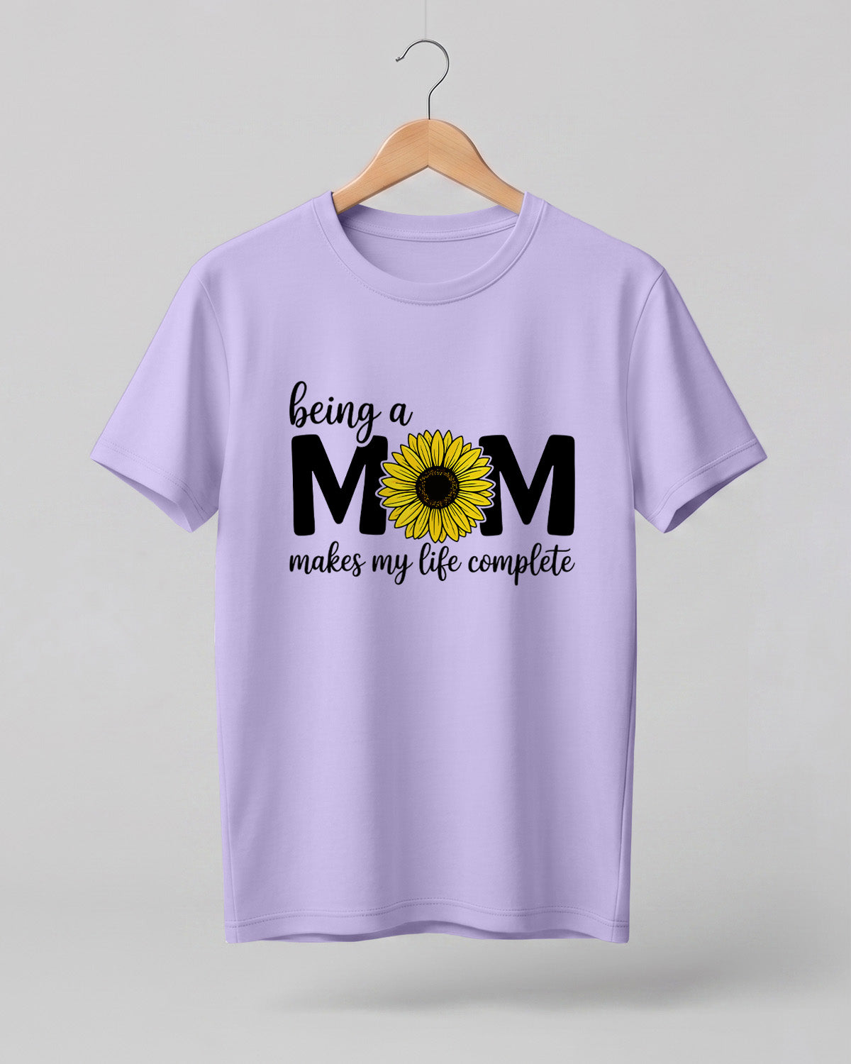 Mom quote graphic half sleeve t-shirt featuring “Being a MOM makes my life complete” with sunflower design