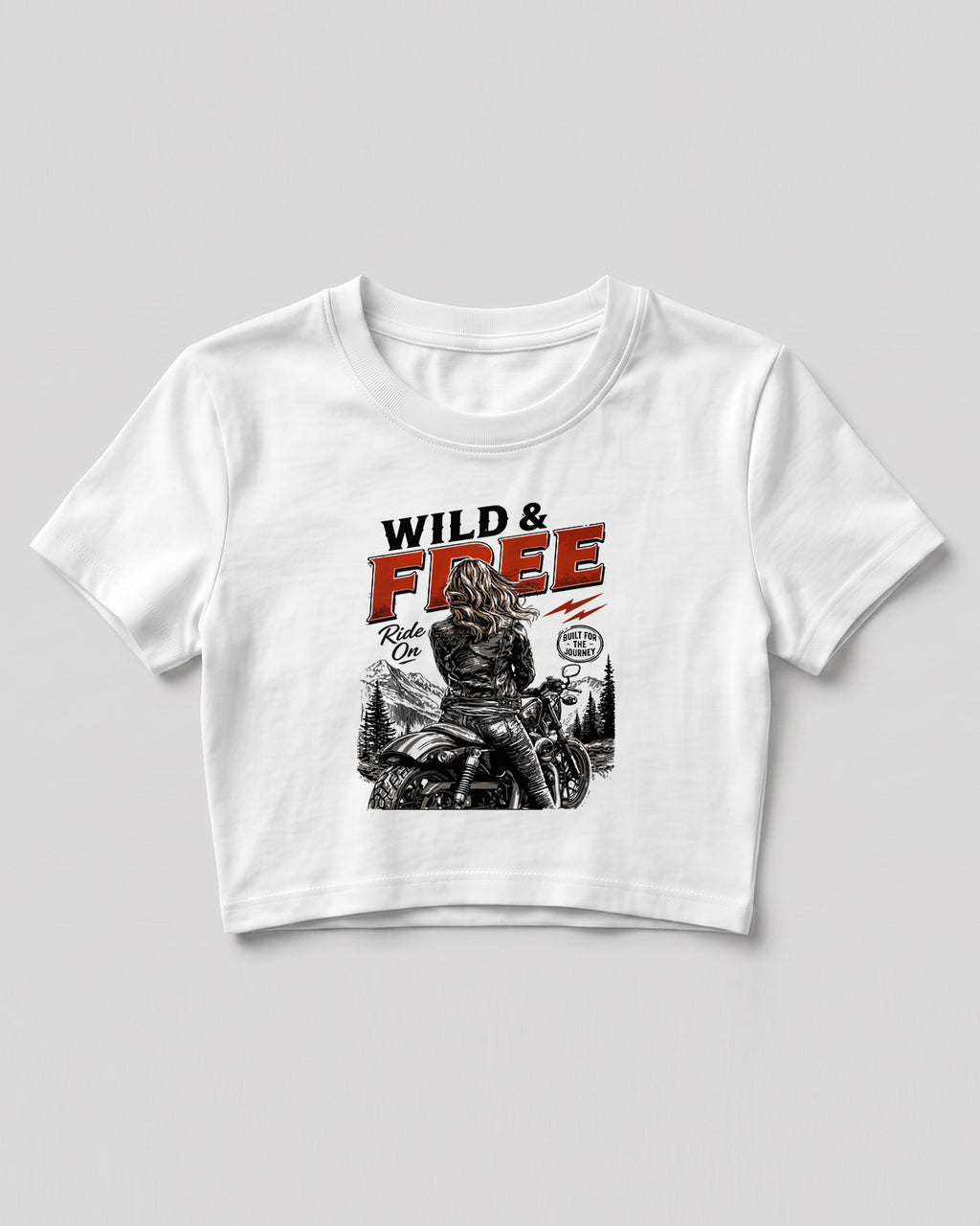 Xenovaurban crop top featuring a woman riding a motorcycle against a scenic mountain backdrop with Wild & Free typography