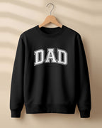 Xenovaurban graphic sweatshirt featuring bold varsity-style “DAD” typography.