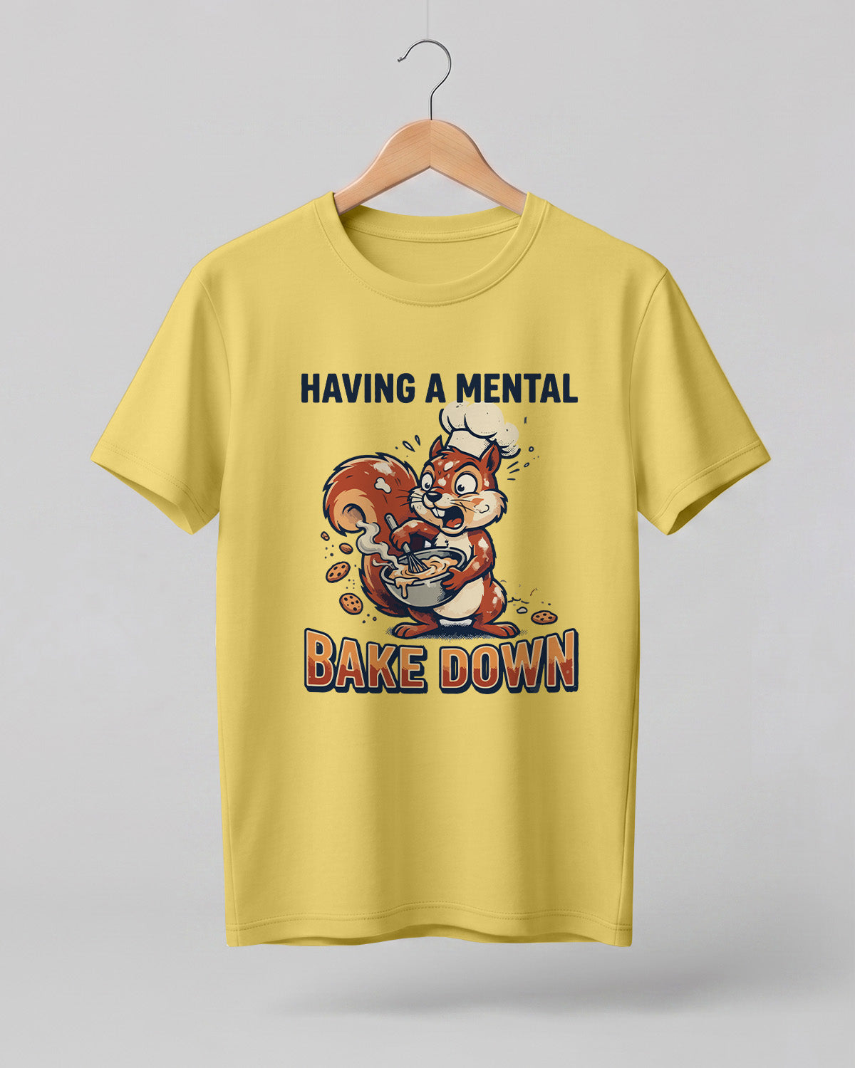 Foodie graphic half sleeve t-shirt featuring cartoon squirrel baking illustration with “Having a Mental Bake Down” typography printed on premium cotton fabric.