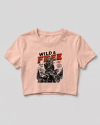 Xenovaurban crop top featuring a woman riding a motorcycle against a scenic mountain backdrop with Wild & Free typography