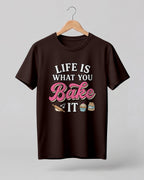 Foodie graphic half sleeve t-shirt featuring “Life Is What You Bake It” typography with colorful baking illustrations printed on premium cotton fabric.