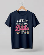 Foodie graphic half sleeve t-shirt featuring “Life Is What You Bake It” typography with colorful baking illustrations printed on premium cotton fabric.