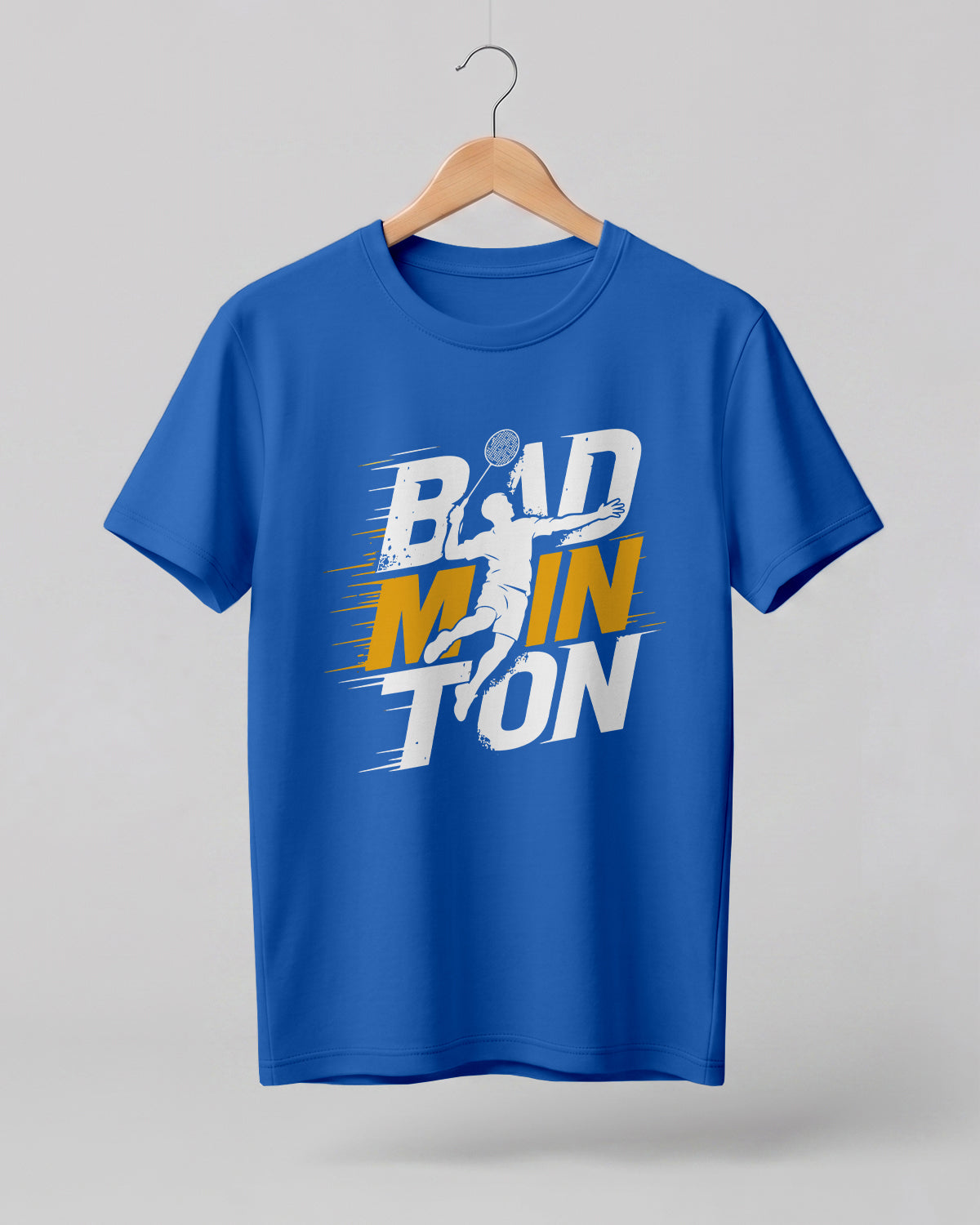Motivational sports graphic half sleeve t-shirt featuring bold “Badminton” typography with dynamic player silhouette printed on premium cotton fabric.