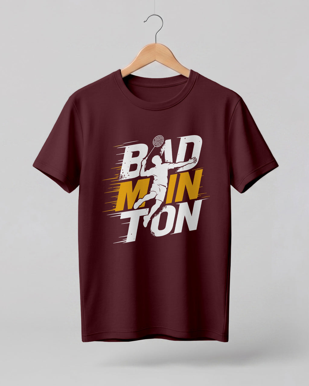 Motivational sports graphic half sleeve t-shirt featuring bold “Badminton” typography with dynamic player silhouette printed on premium cotton fabric.