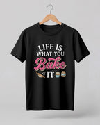 Foodie graphic half sleeve t-shirt featuring “Life Is What You Bake It” typography with colorful baking illustrations printed on premium cotton fabric.
