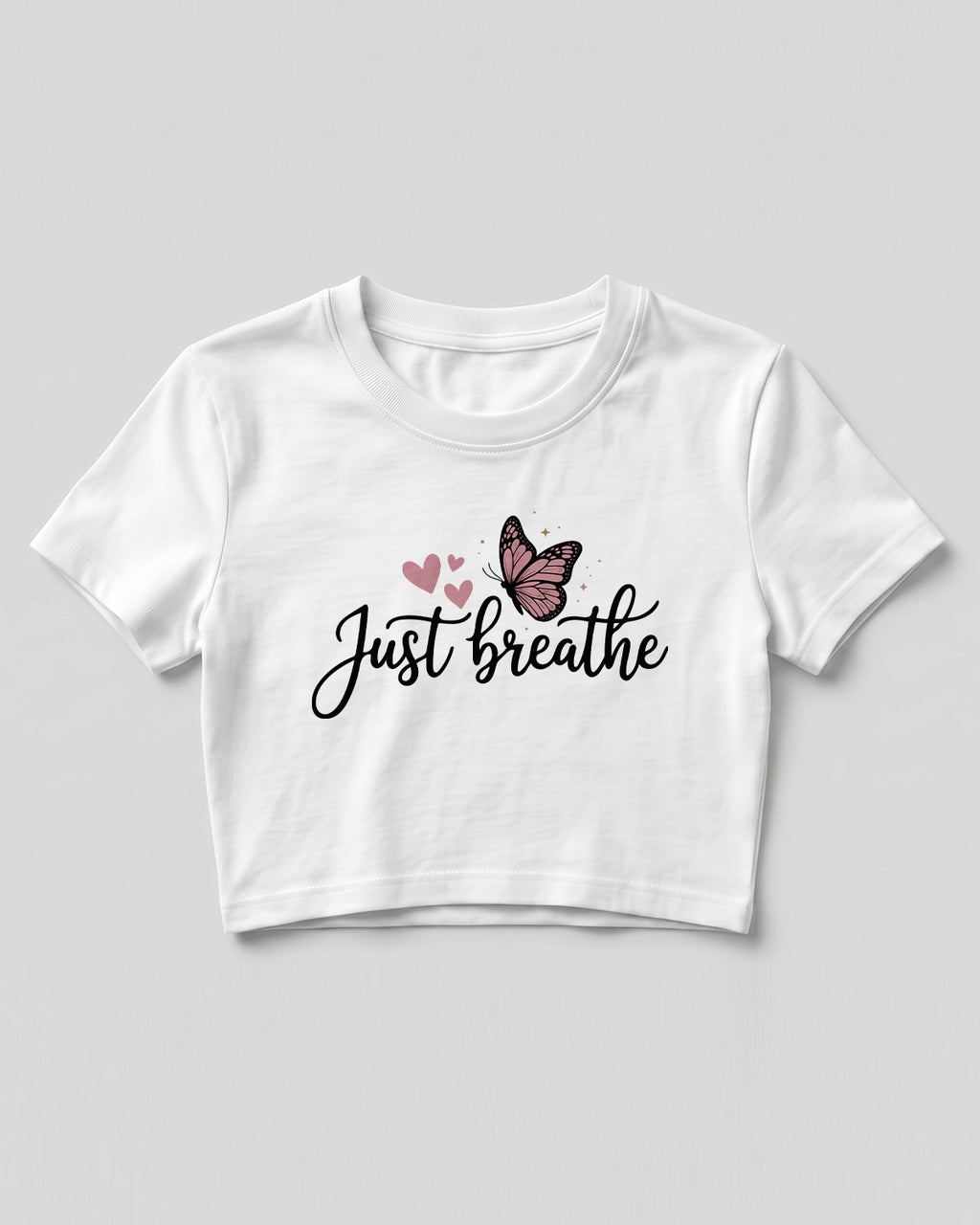 Motivational graphic crop top featuring Just Breathe typography design with butterfly artwork on cotton fabric