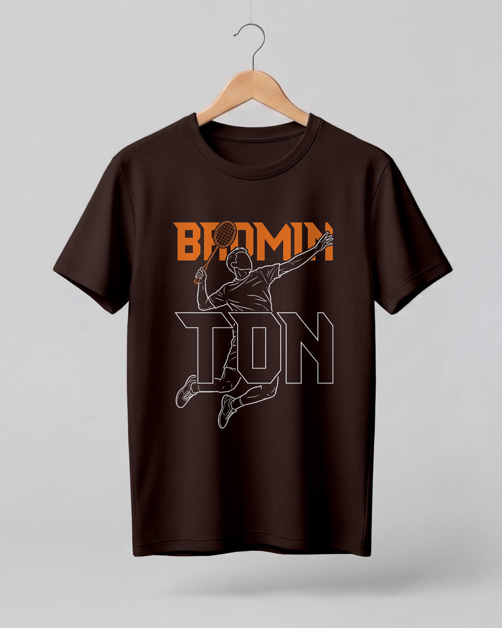 Motivational sports graphic half sleeve t-shirt featuring “Badminton” typography with player outline silhouette printed on premium cotton fabric.