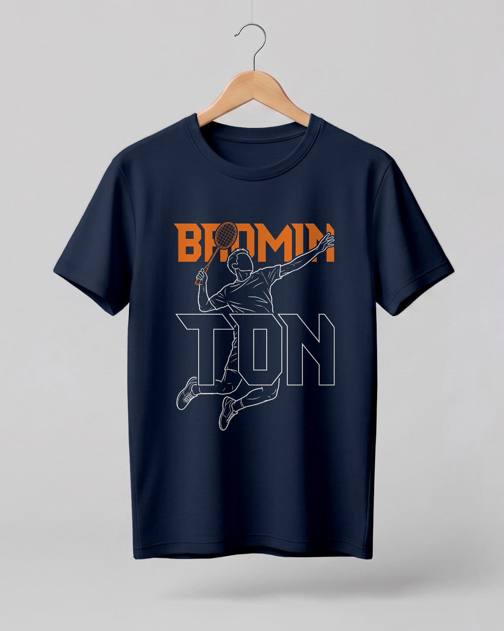 Motivational sports graphic half sleeve t-shirt featuring “Badminton” typography with player outline silhouette printed on premium cotton fabric.