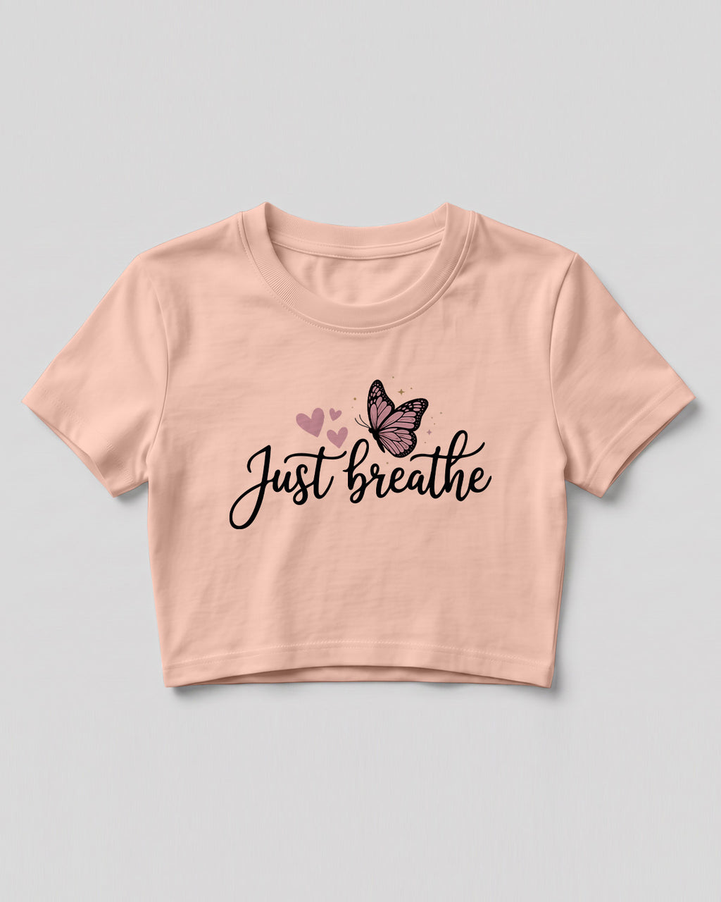 Motivational graphic crop top featuring Just Breathe typography design with butterfly artwork on cotton fabric