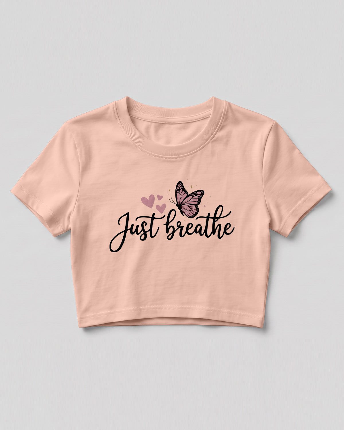 Motivational graphic crop top featuring Just Breathe typography design with butterfly artwork on cotton fabric