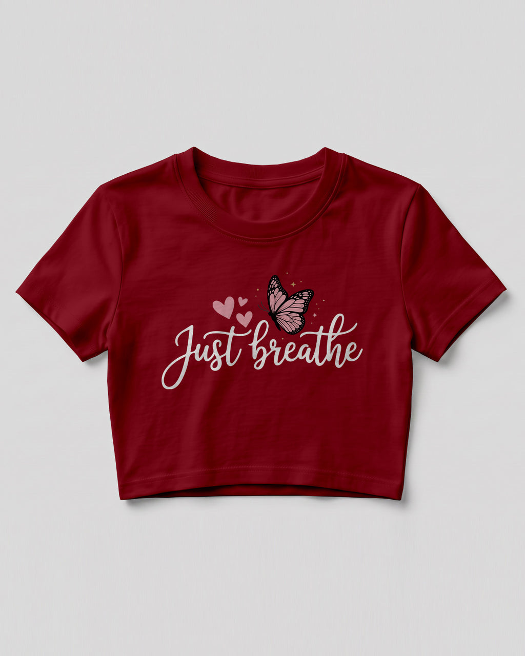 Motivational graphic crop top featuring Just Breathe typography design with butterfly artwork on cotton fabric