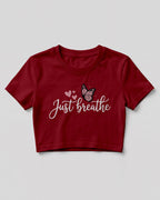 Motivational graphic crop top featuring Just Breathe typography design with butterfly artwork on cotton fabric