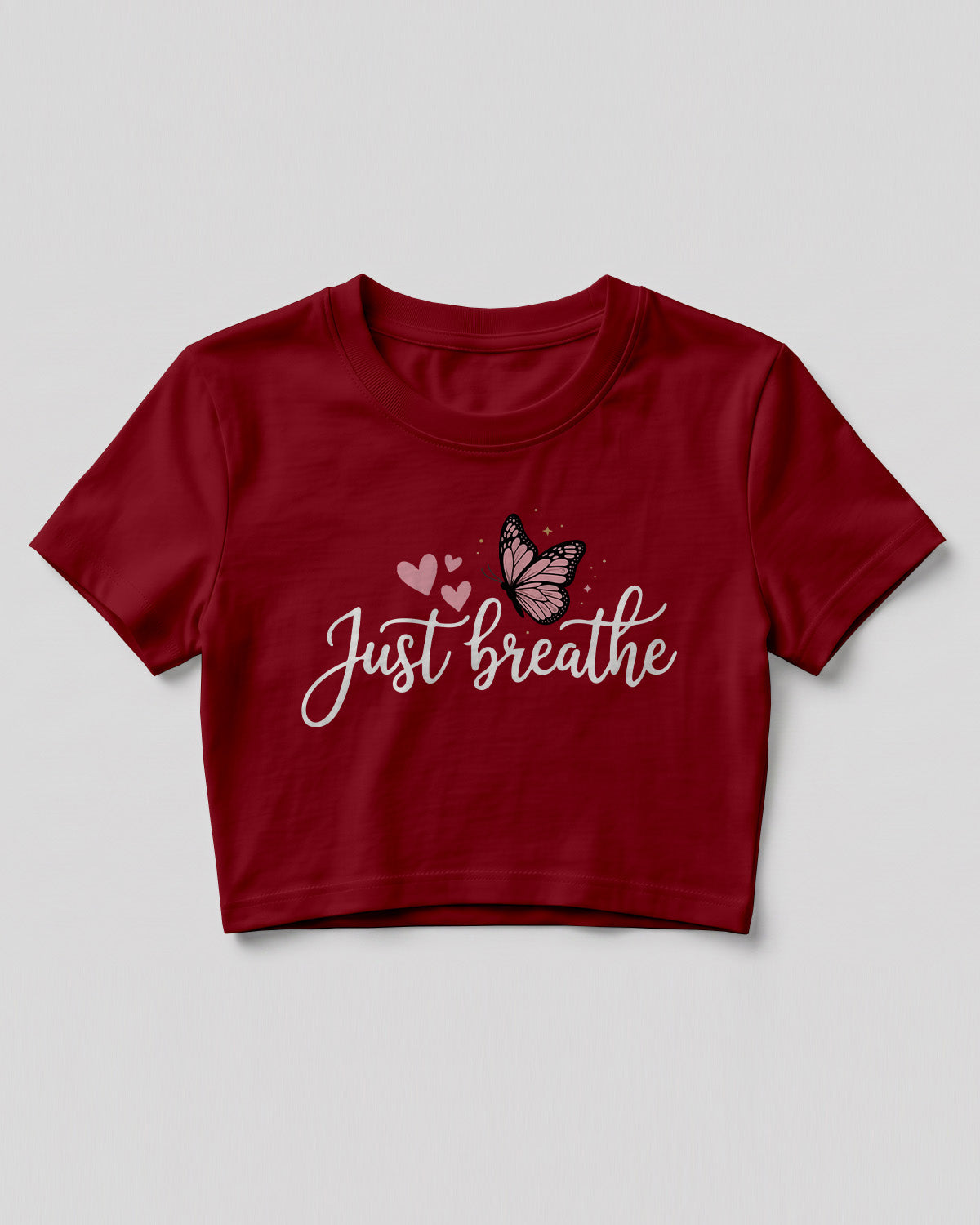 Motivational graphic crop top featuring Just Breathe typography design with butterfly artwork on cotton fabric