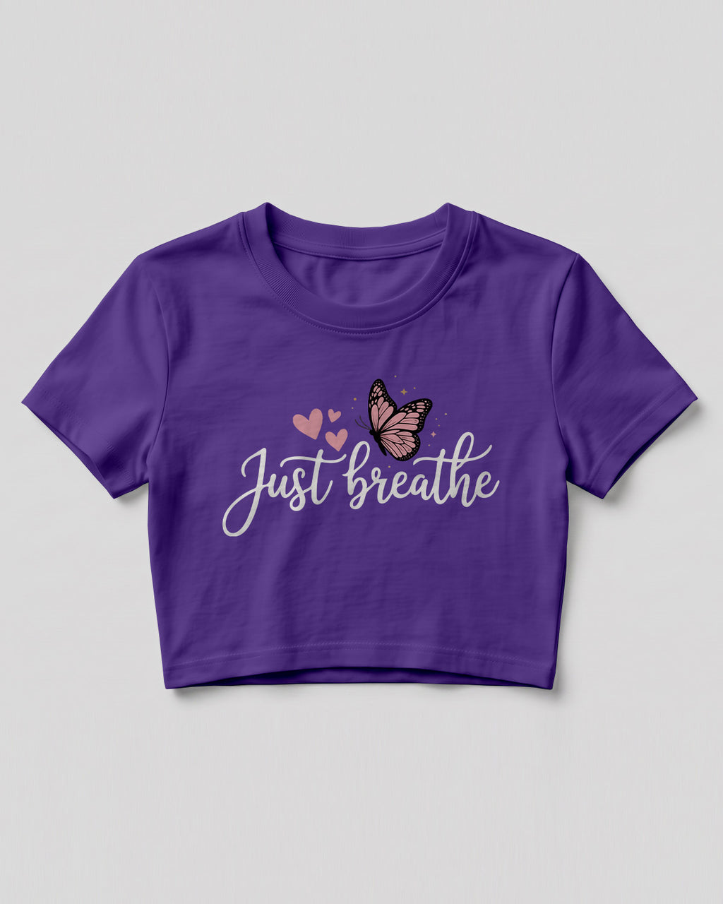 Motivational graphic crop top featuring Just Breathe typography design with butterfly artwork on cotton fabric