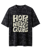 Oversized unisex t-shirt with “Hope Never Quits” motivational typography print, crafted from 220 GSM acid washed cotton.