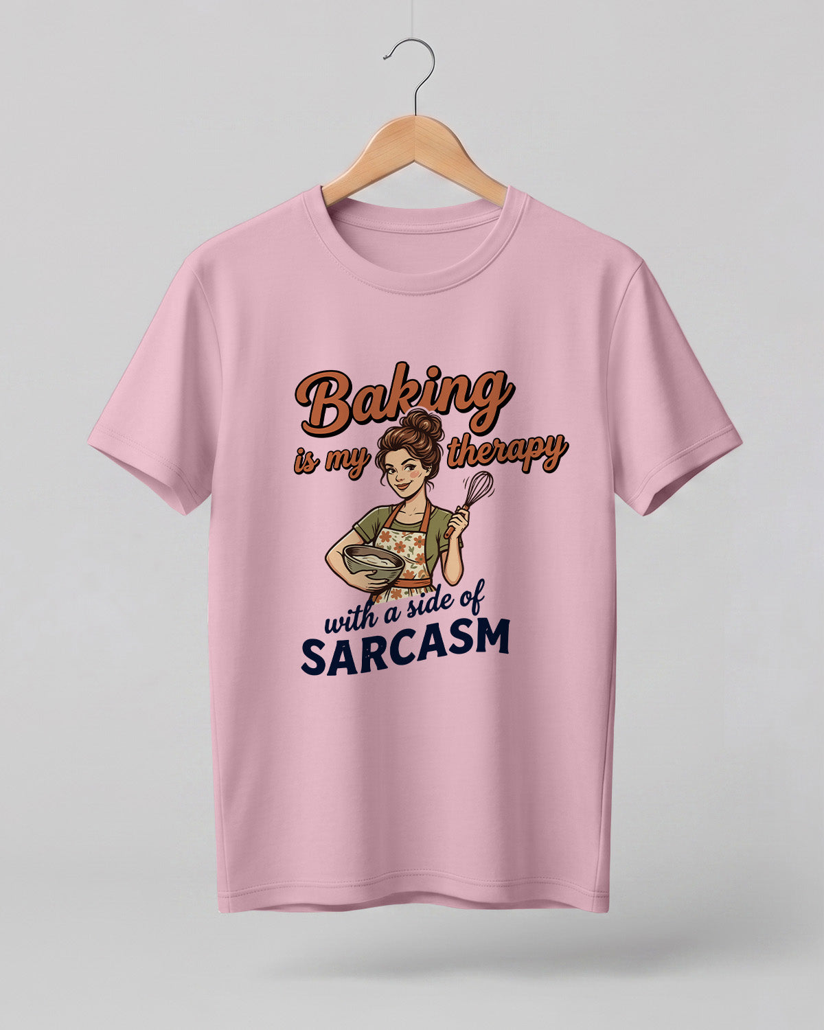 Foodie graphic half sleeve t-shirt featuring cartoon baker illustration with “Baking Is My Therapy with a Side of Sarcasm” typography printed on premium cotton fabric.
