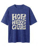 Oversized unisex t-shirt with “Hope Never Quits” motivational typography print, crafted from 220 GSM acid washed cotton.