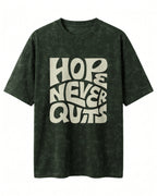 Oversized unisex t-shirt with “Hope Never Quits” motivational typography print, crafted from 220 GSM acid washed cotton.