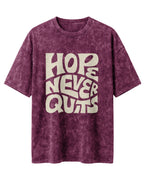 Oversized unisex t-shirt with “Hope Never Quits” motivational typography print, crafted from 220 GSM acid washed cotton.