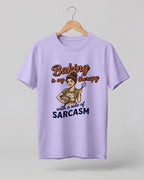 Foodie graphic half sleeve t-shirt featuring cartoon baker illustration with “Baking Is My Therapy with a Side of Sarcasm” typography printed on premium cotton fabric.