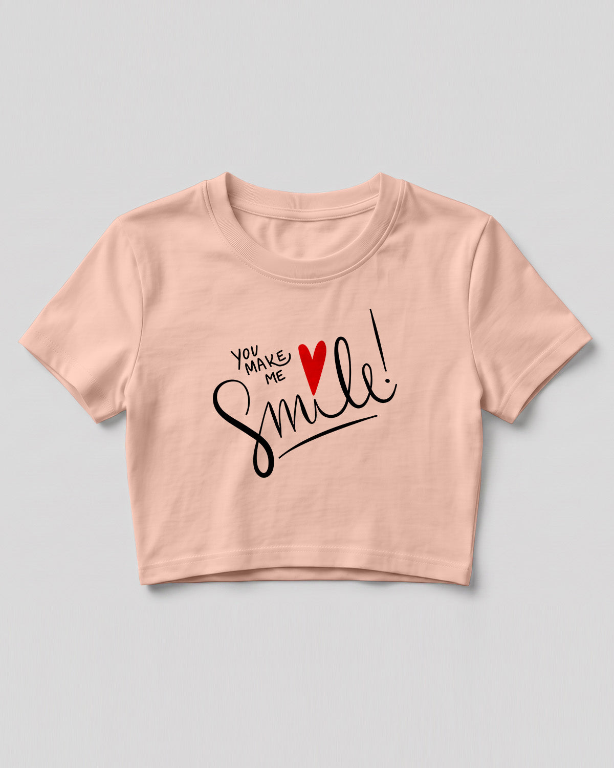 Motivational graphic crop top featuring You Make Me Smile typography design with heart graphic on cotton fabric