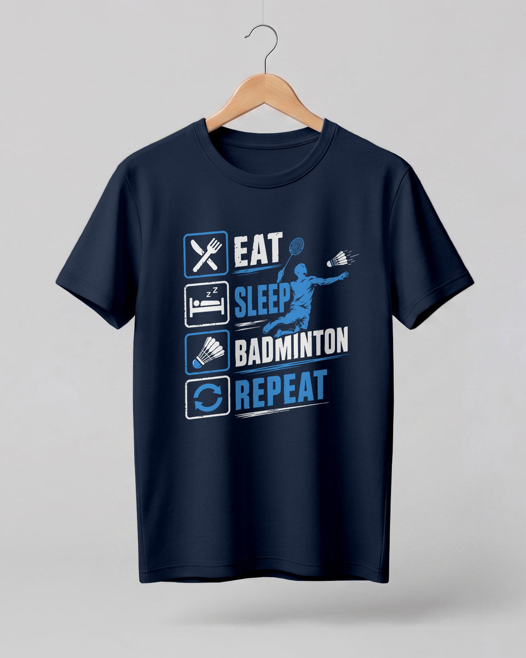 Motivational sports graphic half sleeve t-shirt featuring Eat Sleep Badminton Repeat typography with icons printed on premium cotton fabric.
