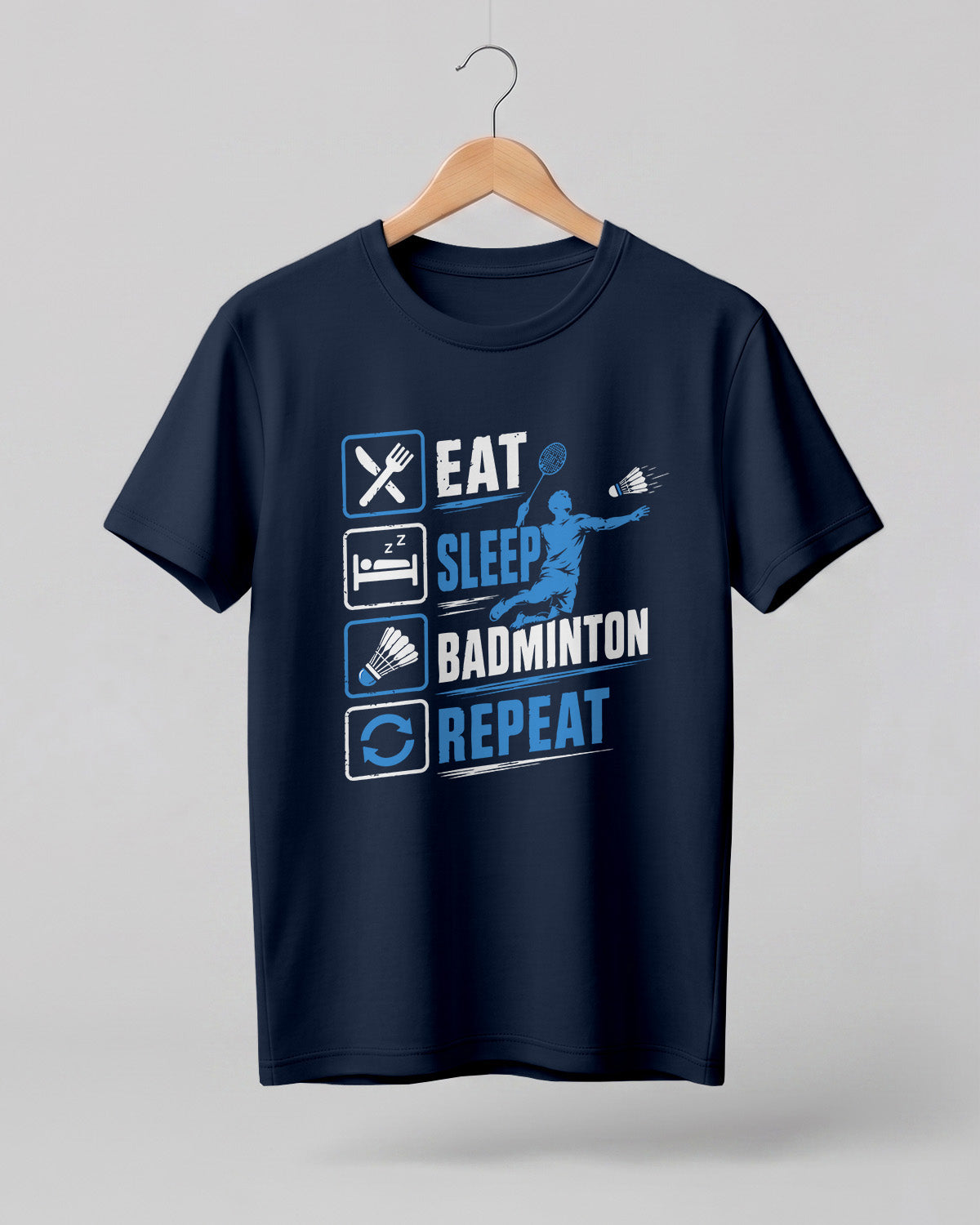 Motivational sports graphic half sleeve t-shirt featuring Eat Sleep Badminton Repeat typography with icons printed on premium cotton fabric.