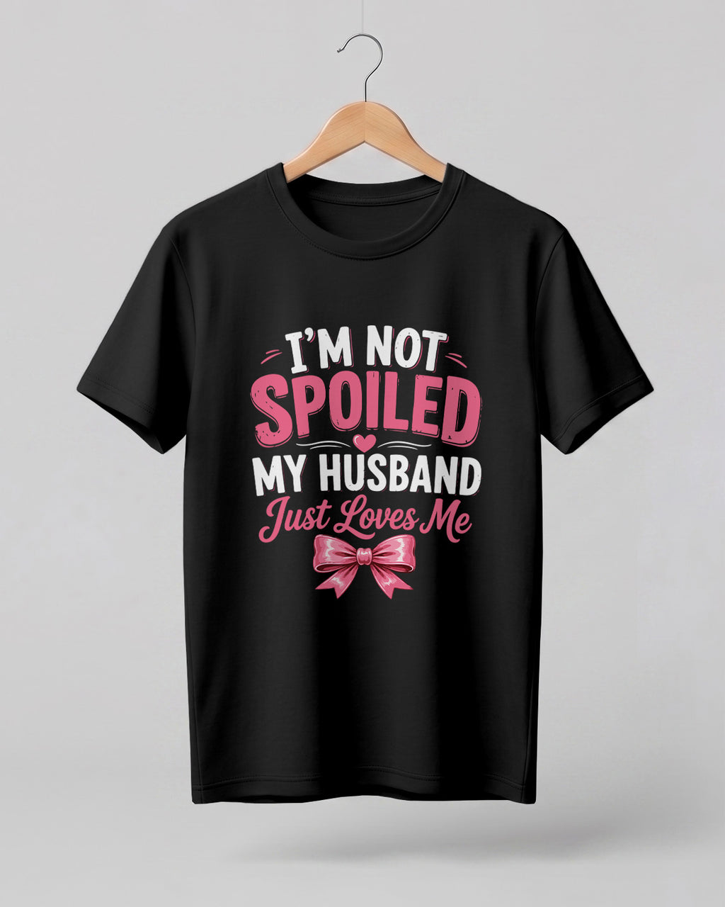 Funny husband quote graphic half sleeve t-shirt featuring “I'm Not Spoiled, My Husband Just Loves Me” with a pink bow design