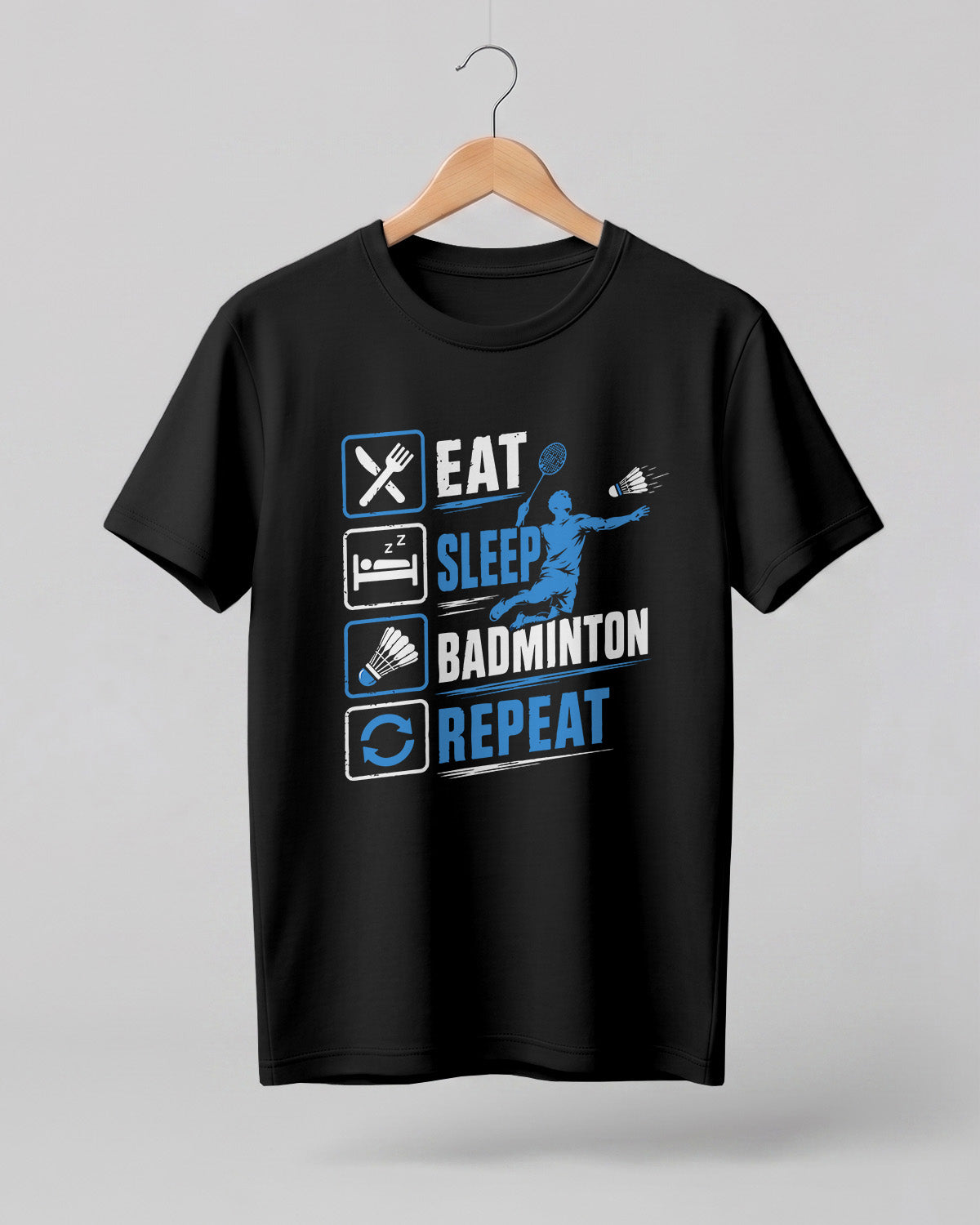 Motivational sports graphic half sleeve t-shirt featuring Eat Sleep Badminton Repeat typography with icons printed on premium cotton fabric.