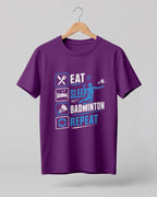 Motivational sports graphic half sleeve t-shirt featuring Eat Sleep Badminton Repeat typography with icons printed on premium cotton fabric.