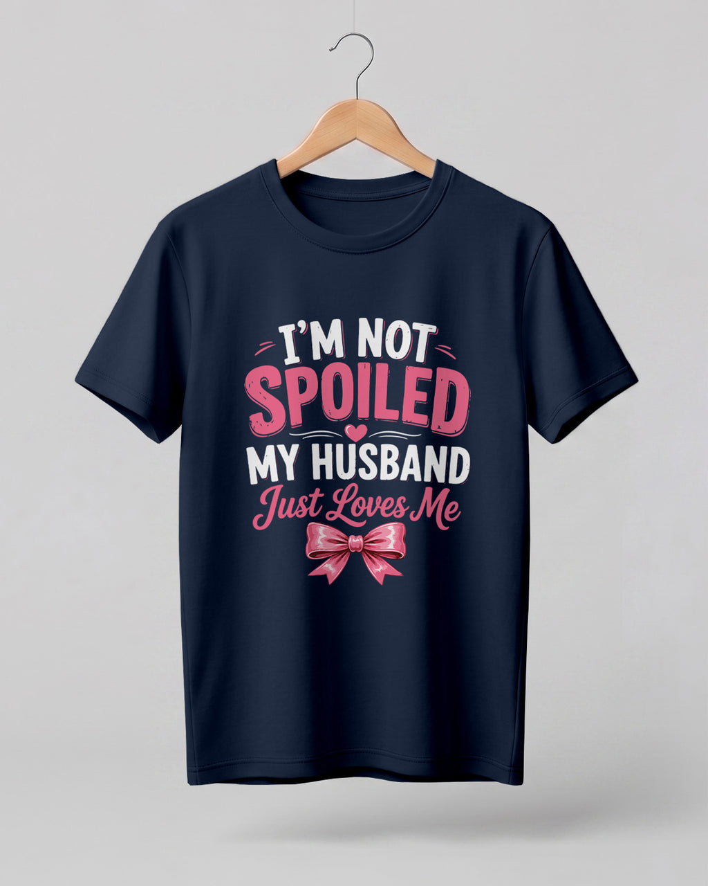 Funny husband quote graphic half sleeve t-shirt featuring “I'm Not Spoiled, My Husband Just Loves Me” with a pink bow design
