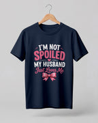 Funny husband quote graphic half sleeve t-shirt featuring “I'm Not Spoiled, My Husband Just Loves Me” with a pink bow design