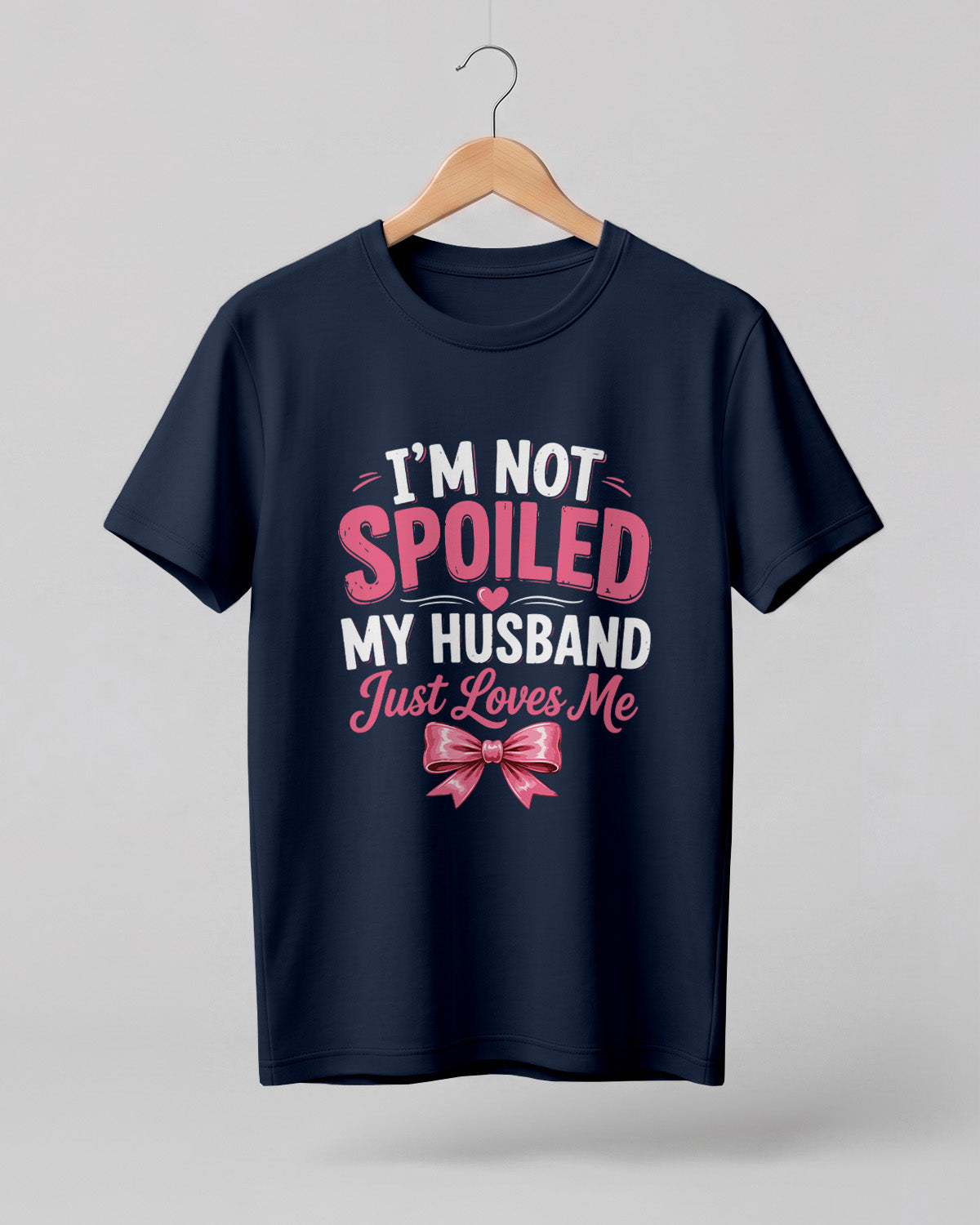 Funny husband quote graphic half sleeve t-shirt featuring “I'm Not Spoiled, My Husband Just Loves Me” with a pink bow design
