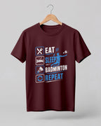 Motivational sports graphic half sleeve t-shirt featuring Eat Sleep Badminton Repeat typography with icons printed on premium cotton fabric.