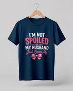 Funny husband quote graphic half sleeve t-shirt featuring “I'm Not Spoiled, My Husband Just Loves Me” with a pink bow design