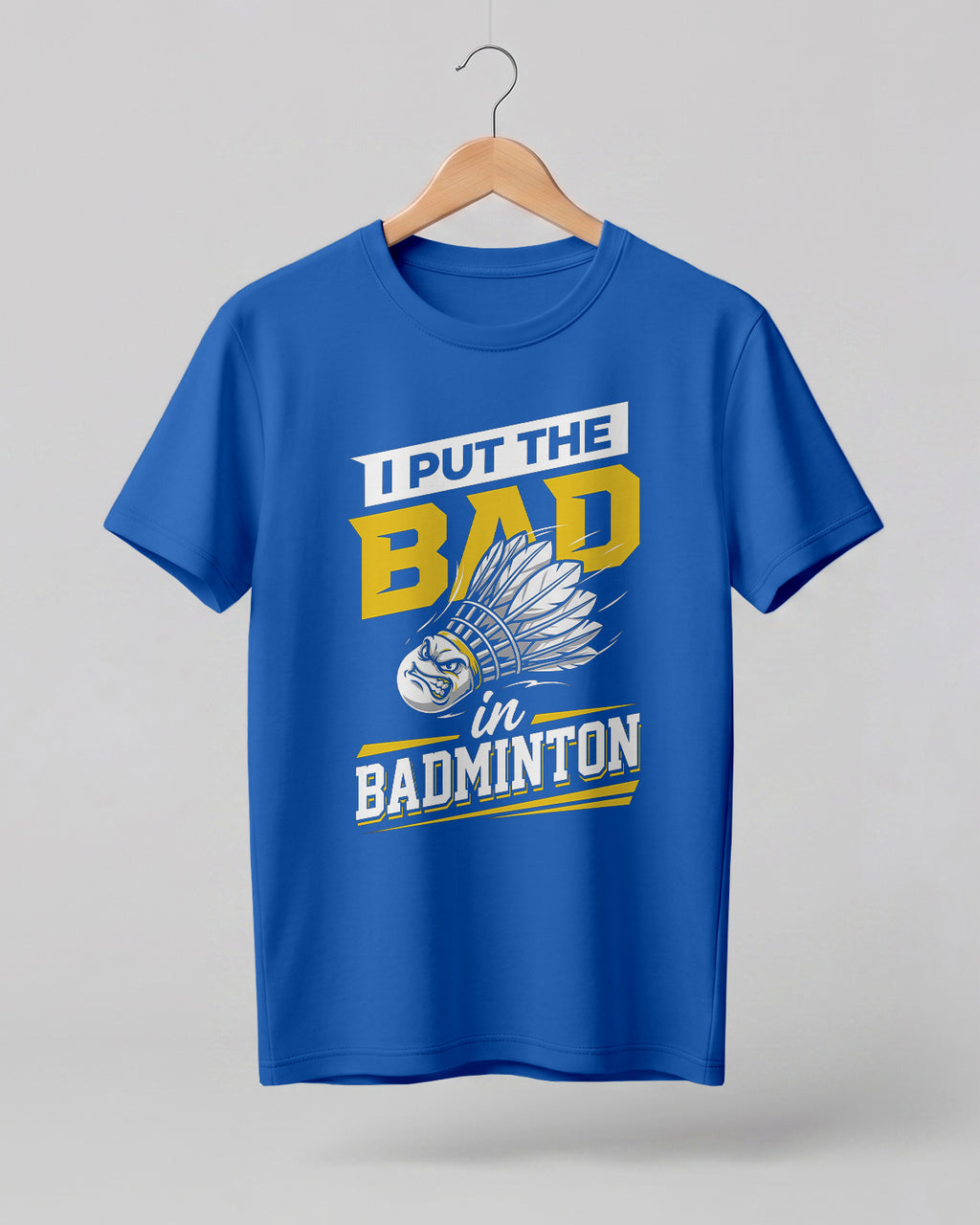 Humorous sports graphic half sleeve t-shirt featuring “I Put the Bad in Badminton” typography with shuttlecock illustration printed on premium cotton fabric.