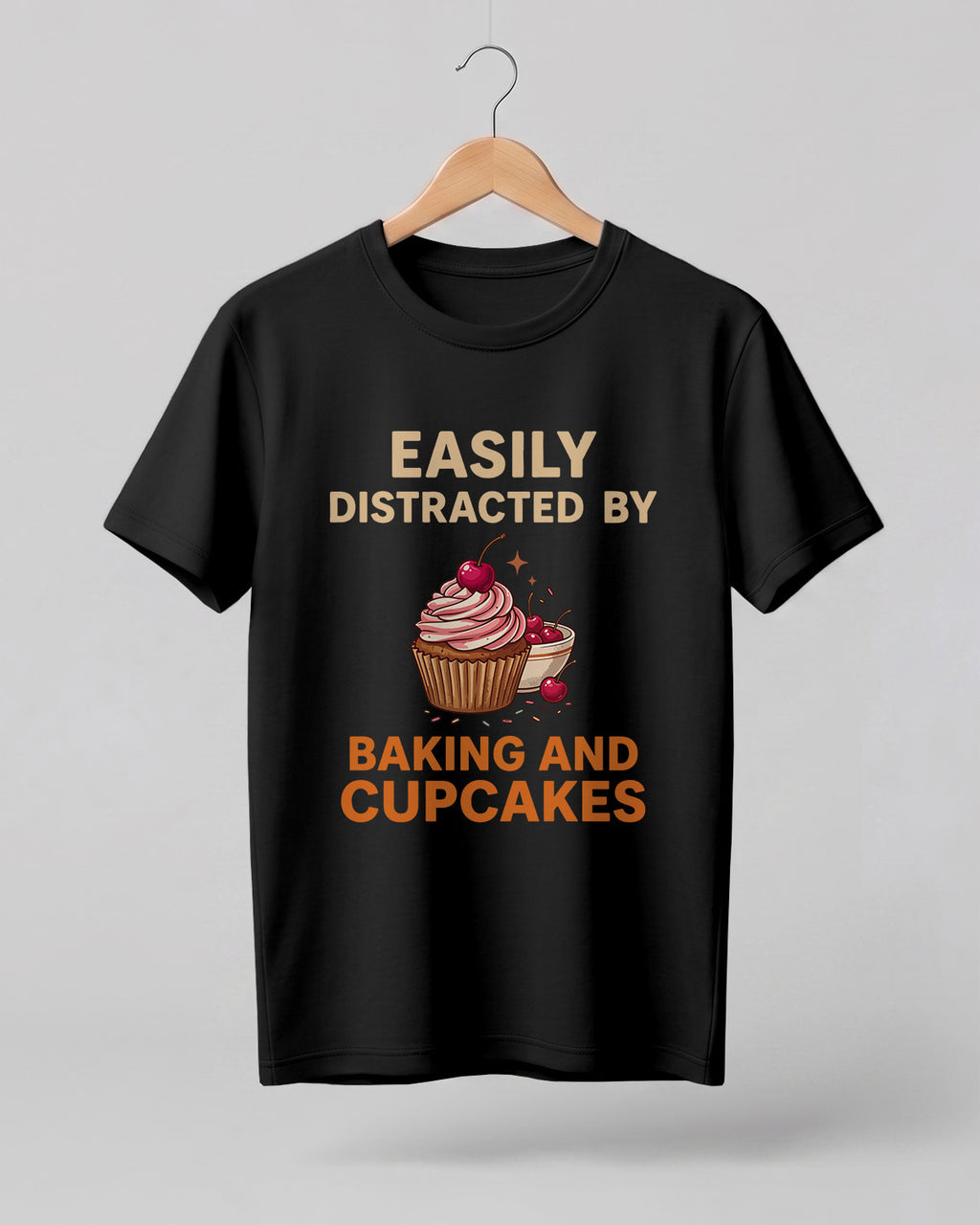 Foodie graphic half sleeve t-shirt featuring “Easily Distracted by Baking and Cupcakes” typography with colorful cupcake illustration printed on premium cotton fabric.