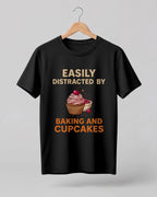 Foodie graphic half sleeve t-shirt featuring “Easily Distracted by Baking and Cupcakes” typography with colorful cupcake illustration printed on premium cotton fabric.