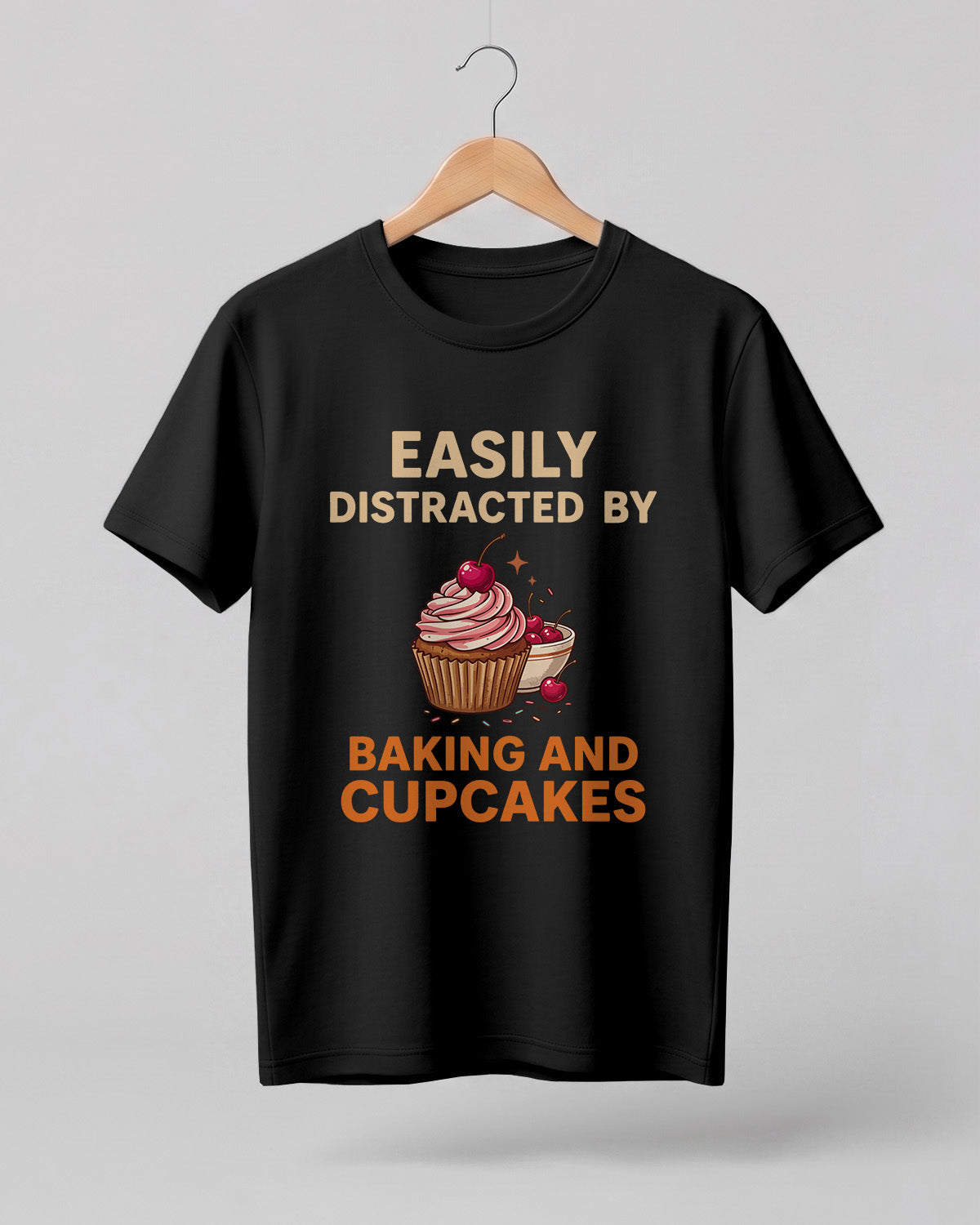 Foodie graphic half sleeve t-shirt featuring “Easily Distracted by Baking and Cupcakes” typography with colorful cupcake illustration printed on premium cotton fabric.